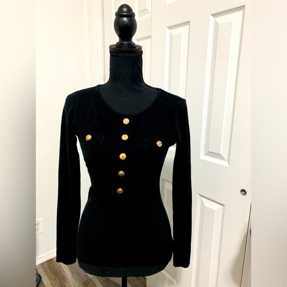 Women’s black top with gold buttons